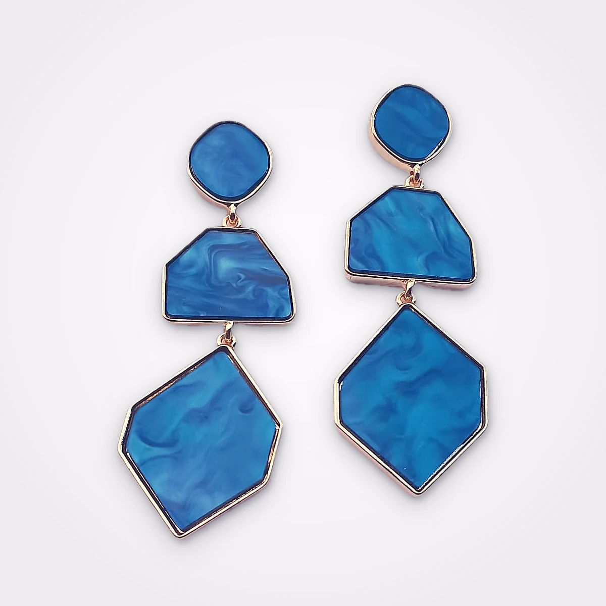 Gold Tone Drop Earrings Featuring Geometrical Shapes In Blue Marbled Resin