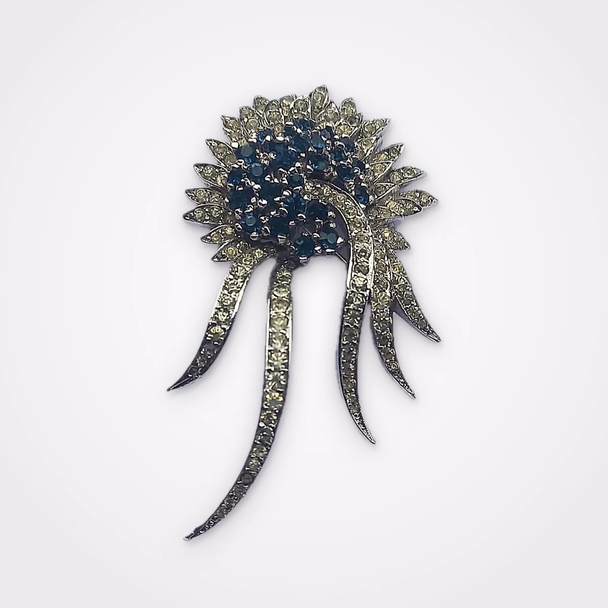 Mid Century Silver Tone Starburst Brooch Adorned With Dark Blue & Clear Rhinestones